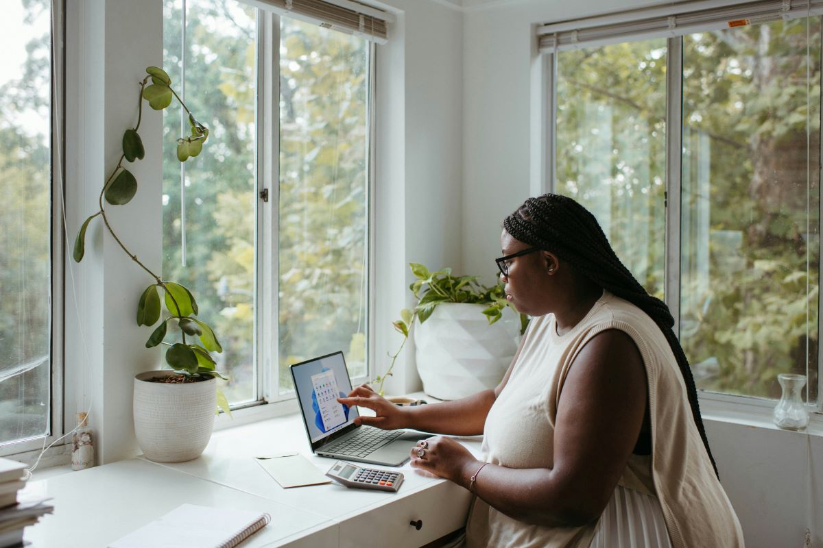 Woman working from home in a white room